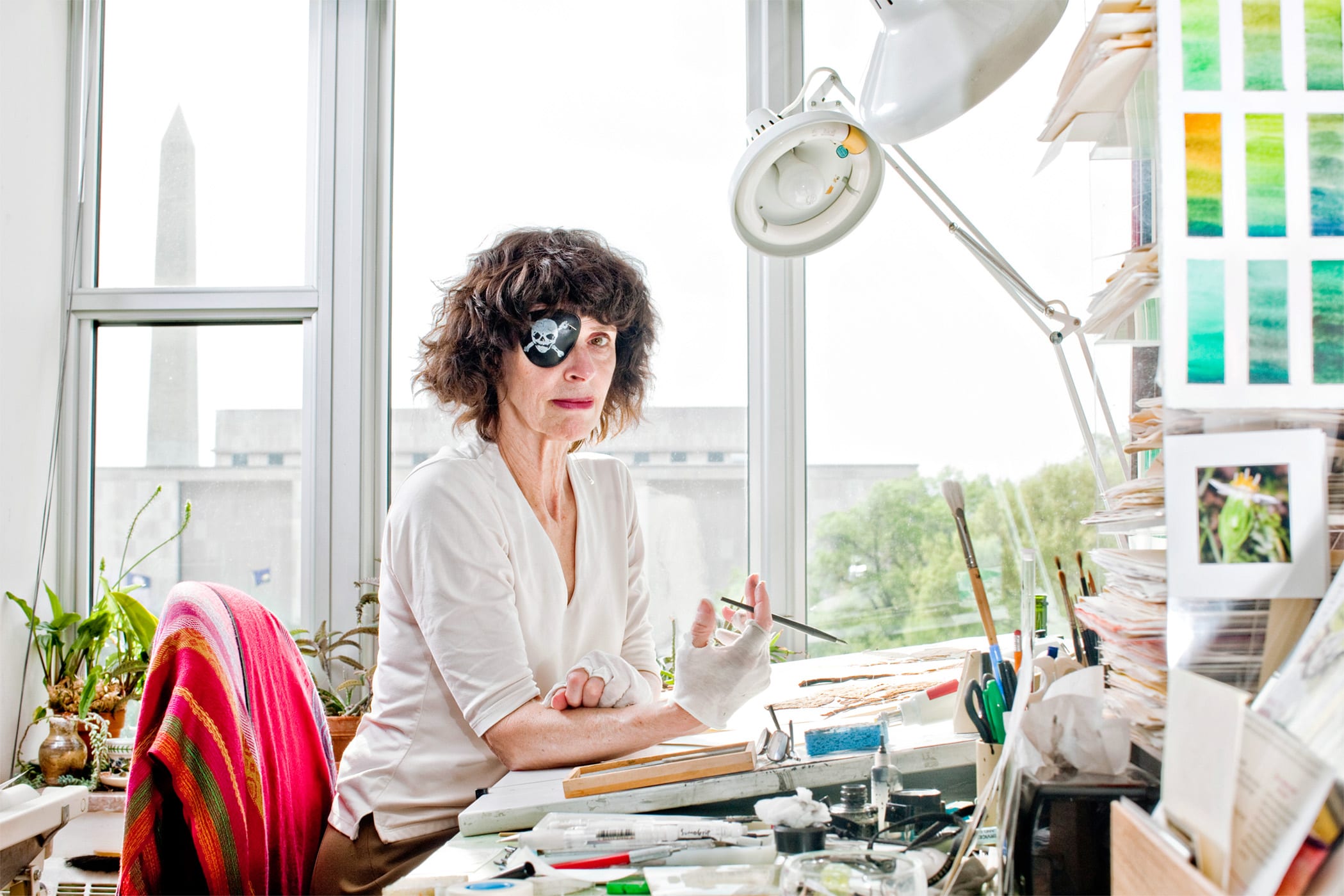 Smithsonian botanical illustrator Alice Tangerini poses for a portrait in her office at the Museum of Natural History in Washington, DC. Tangerini suffered from macular pucker, which is scar tissue that forms on the eye’s macula and can blur and distort vision. Because the hand tracks the eye, in order to keep her lines straight when drawing, she wears a patch over her bad eye. She likes the pirate patch because she says it makes light of a bad situation.