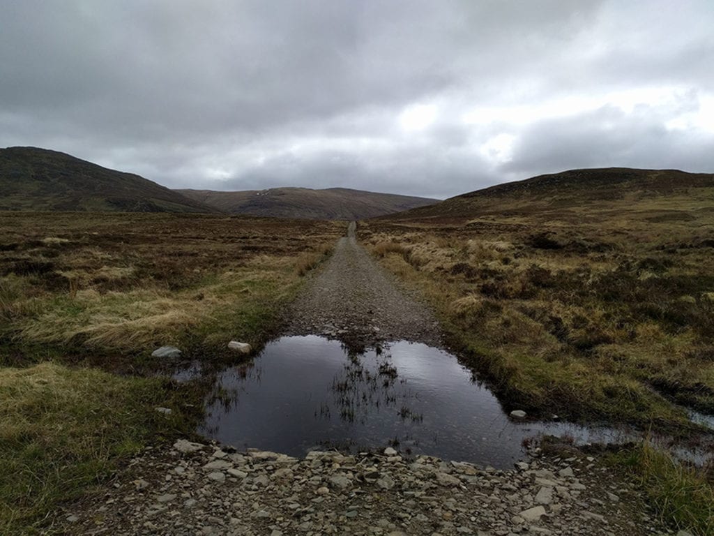 On the way to Corrieyairack Pass using the old General Wade Military Road (built in 1731). The biggest decision for many Challengers is what kind of shoes to bring: hiking boots or non-waterproof trail shoes? Many of the elite hikers choose the latter figuring that they’re going to get wet anyway so why walk in boots that move like cinder blocks? The booters gamble that they can stay dry most of the time and they relish the superior ankle support. My decision? I took both. For this section of the hike, I had on a pair of Italian works-of-art, full-leather Zamberlans. I wore them for about 25% of the journey, mostly during the rougher sections. I wonder what the General’s men wore, almost three hundred years ago, marching across the Cairngorms chasing down the Jacobites? 